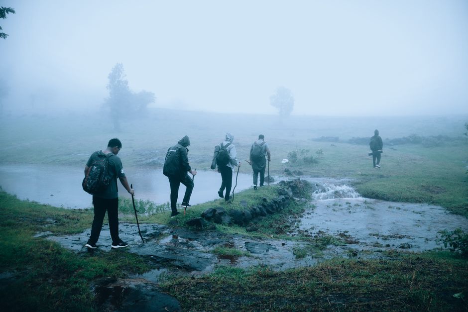 Hikers in foggy countryside